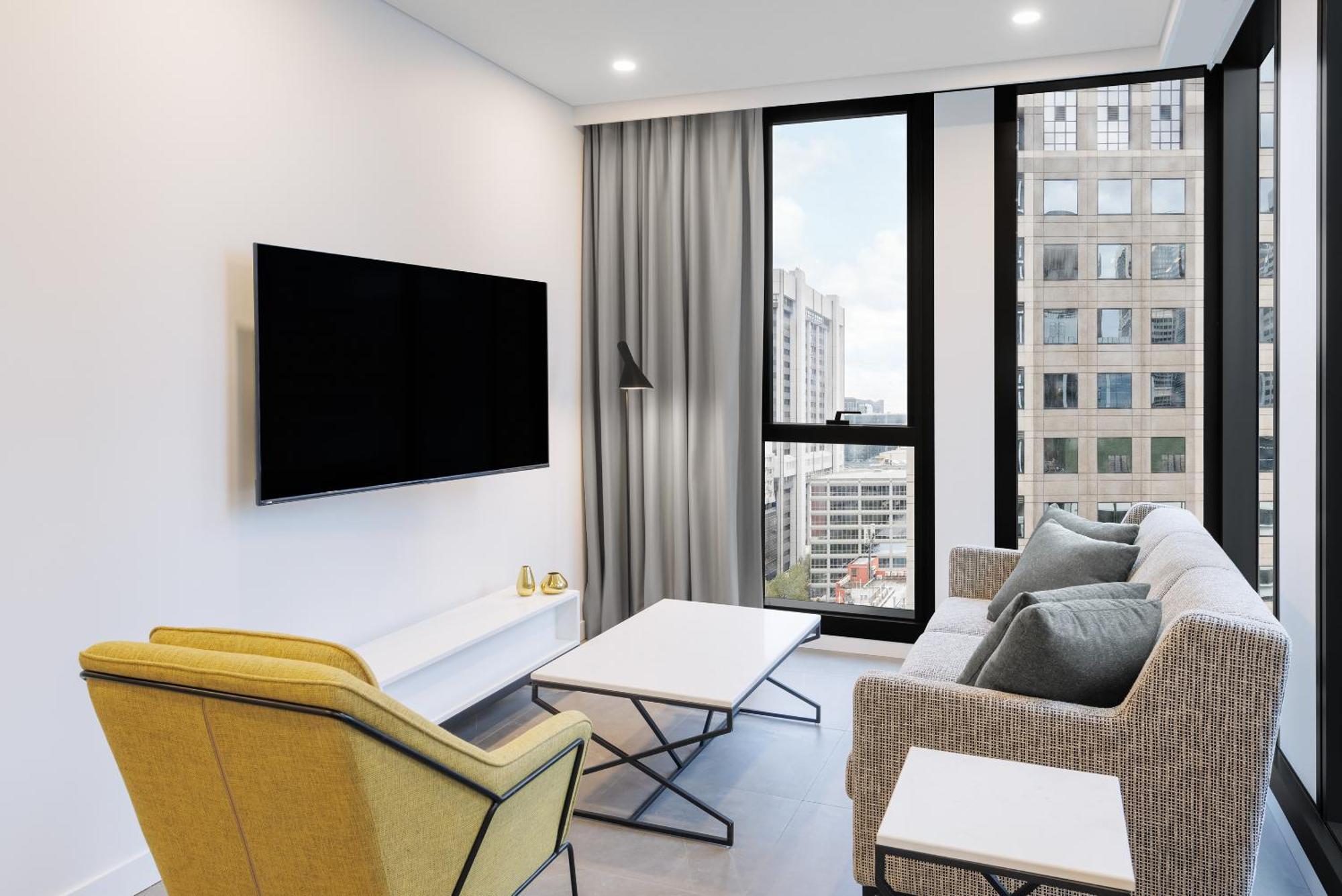 Meriton Suites Мельбурн Экстерьер фото A living room
